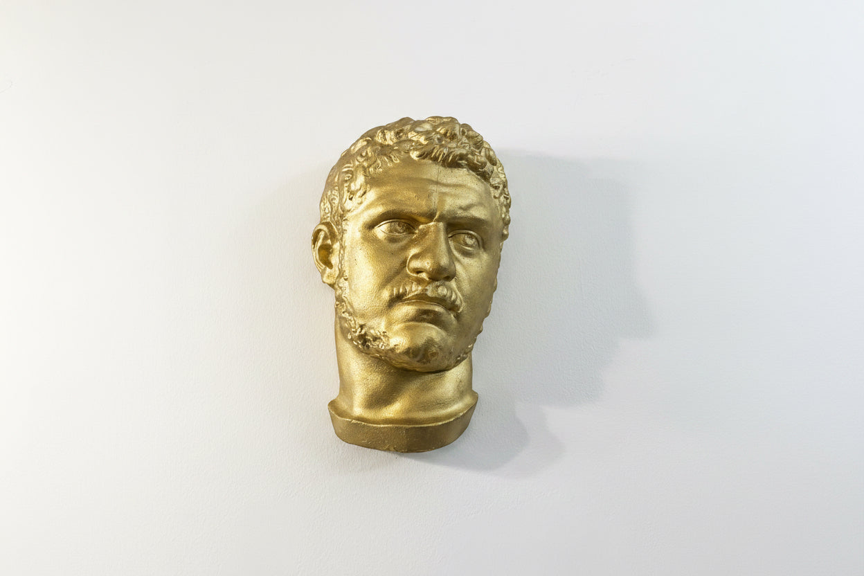 Golden head sculpture by Mikita