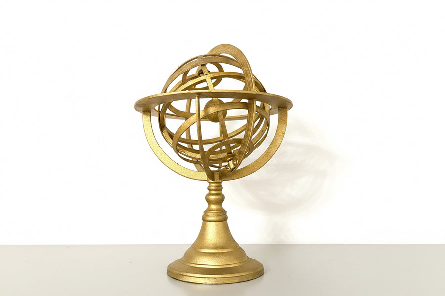 Golden globe sculpture by Mikita